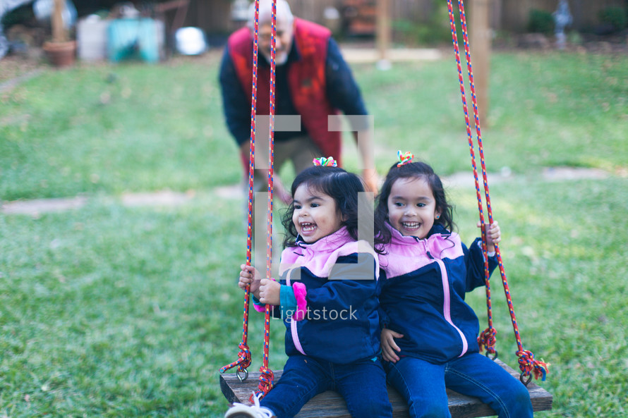 little girls on a swing 