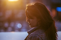 side profile of a young woman at sunset 