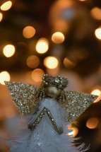 an angel against bokeh Christmas lights 