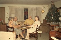Grandparents sitting around a table at Christmas time 