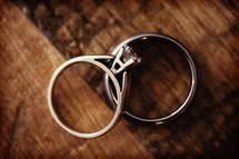 close up of two rings laying together on a table.