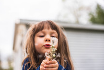 child with dandelions 