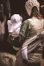 Amish mother carrying an infant 