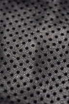 black leather background with holes 