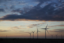 wind turbines in a sky at sunset 