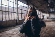 Young Girl with Mask in Empty Broken Factory Hall