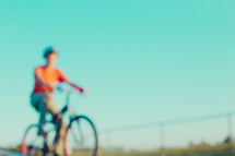 teen boy riding a bike 