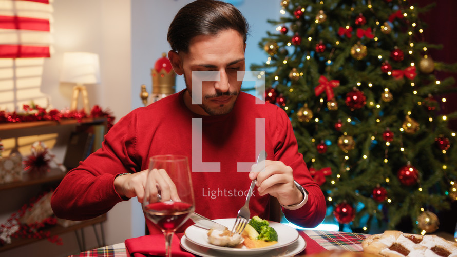 Man enjoying Thanksgiving dinner with USA flag in the background 
