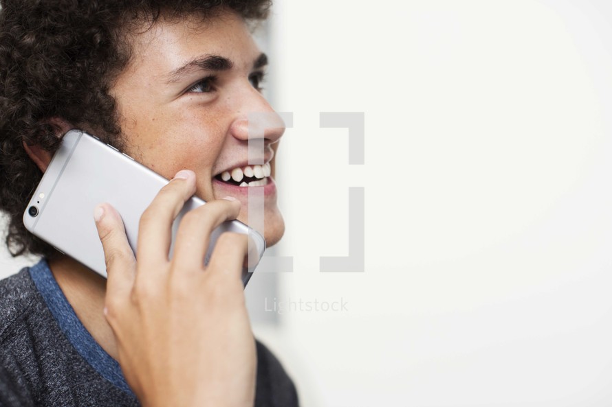 teen boy talking on a cellphone 