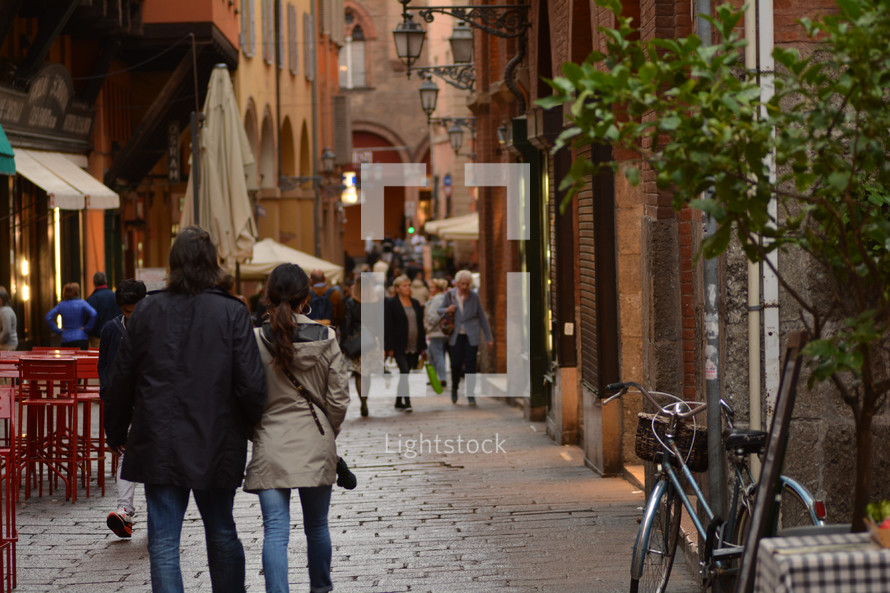 people walking on narrow pedestrian streets in Italy 