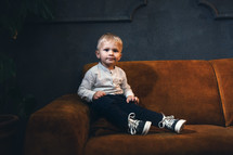 Adorable Handsome Little Cute Boy on Vintage Sofa in Dark Interior