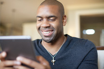 African-American man looking at an iPad screen 