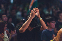 head bowed in prayer at a worship service 