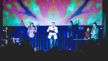 worship leaders singing on stage 