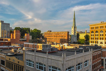 steeple on a church and downtown buildings 