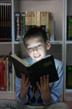Boy reading the Holy Bible