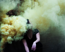a woman sitting in smoke 