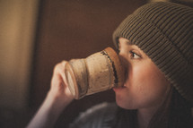 A woman drinking coffee in a mug