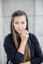 woman wearing a hoodie and a cross ring