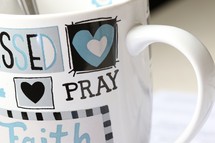 word pray on a coffee mug 