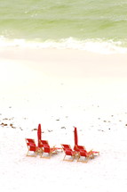 lounge chairs and umbrellas on a beach