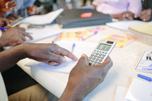 a woman holding a calculator, a man holding a calculator, education in business, training, 