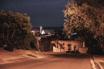 view of a church in a town at night 