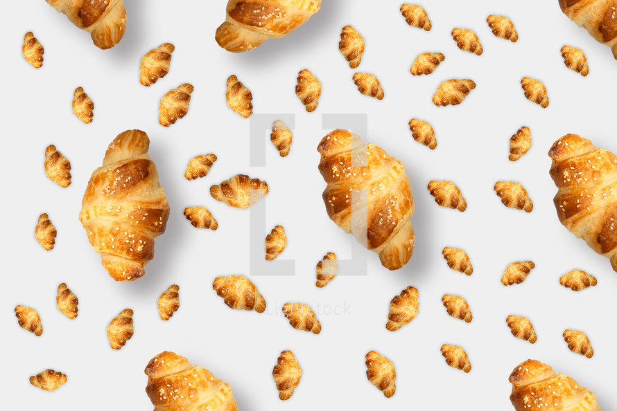 Pattern from croissants isolated on gray background. Bakery pattern with baked croissant.