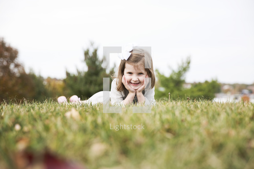 a child lying in the grass 