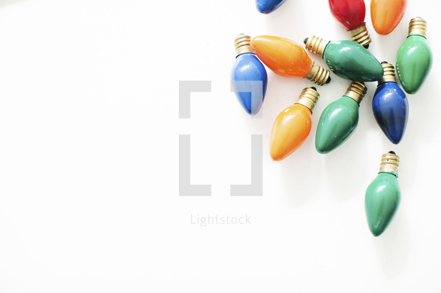 colored Christmas light bulbs isolated on white.