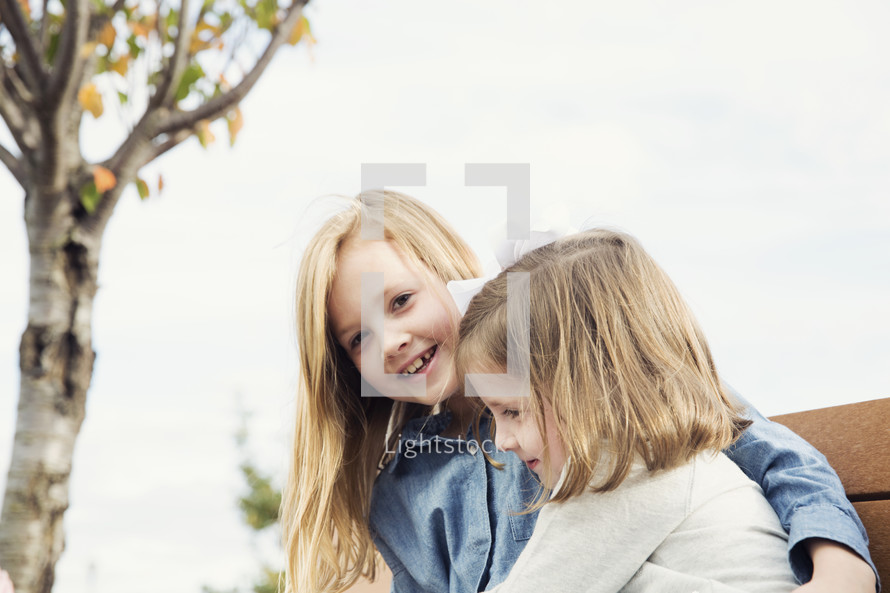 sisters hugging outdoors