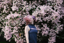 woman with pink hair tossing her hair 