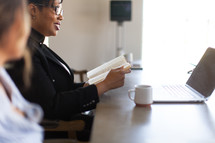 woman reading a Bible in the office 