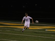 a man kicking a soccer ball 