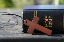 wooden cross necklace and Bible 