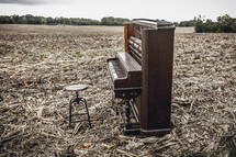 a piano in a plowed field 