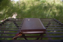 A Bible on a metal table outdoors