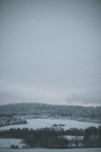 distant farmhouse in the snow 