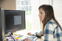 a woman sitting behind a computer 