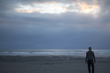 man standing alone on a beach 