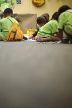 kids coloring on the floor at VBS 