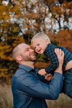 a portrait of a father and son outdoors in fall 