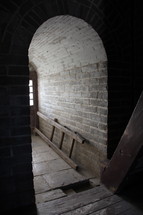 sunlight through a window shining into a cellar hallway