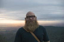 man with a heavy beard standing outdoors 