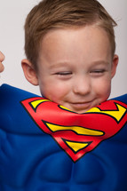 a boy child in a superman costume 