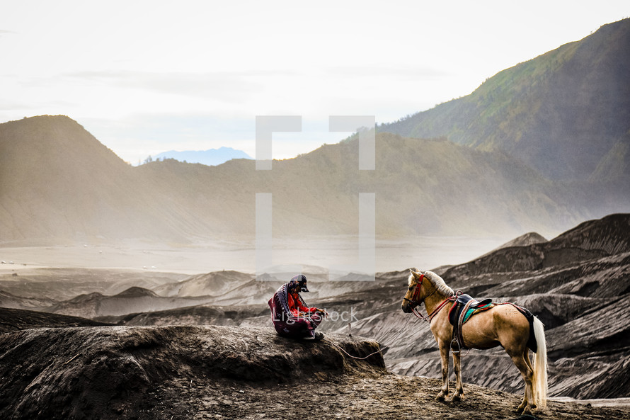 man and his horse on rugged mountains 