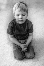 toddler kneeling in prayer 