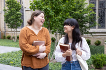 two women holding a Bible app 