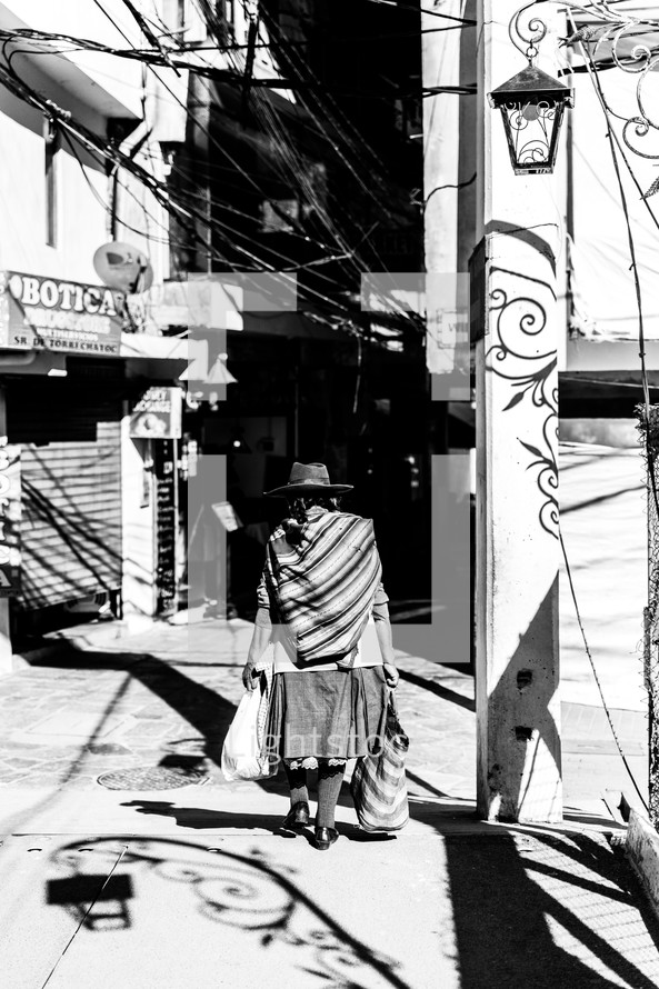 woman walking on a sidewalk in Peru