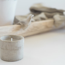 linen fabric on a wood tray and votive candle 